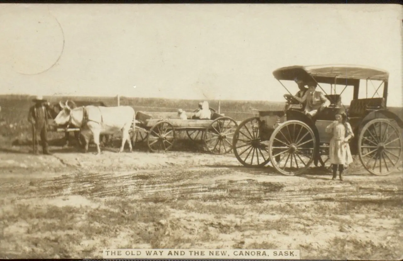 The old way and the new: ox-drawn wagon and an early automobile, about 1910